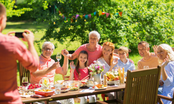 happy-family-photographing-at-dinner-in-garden
